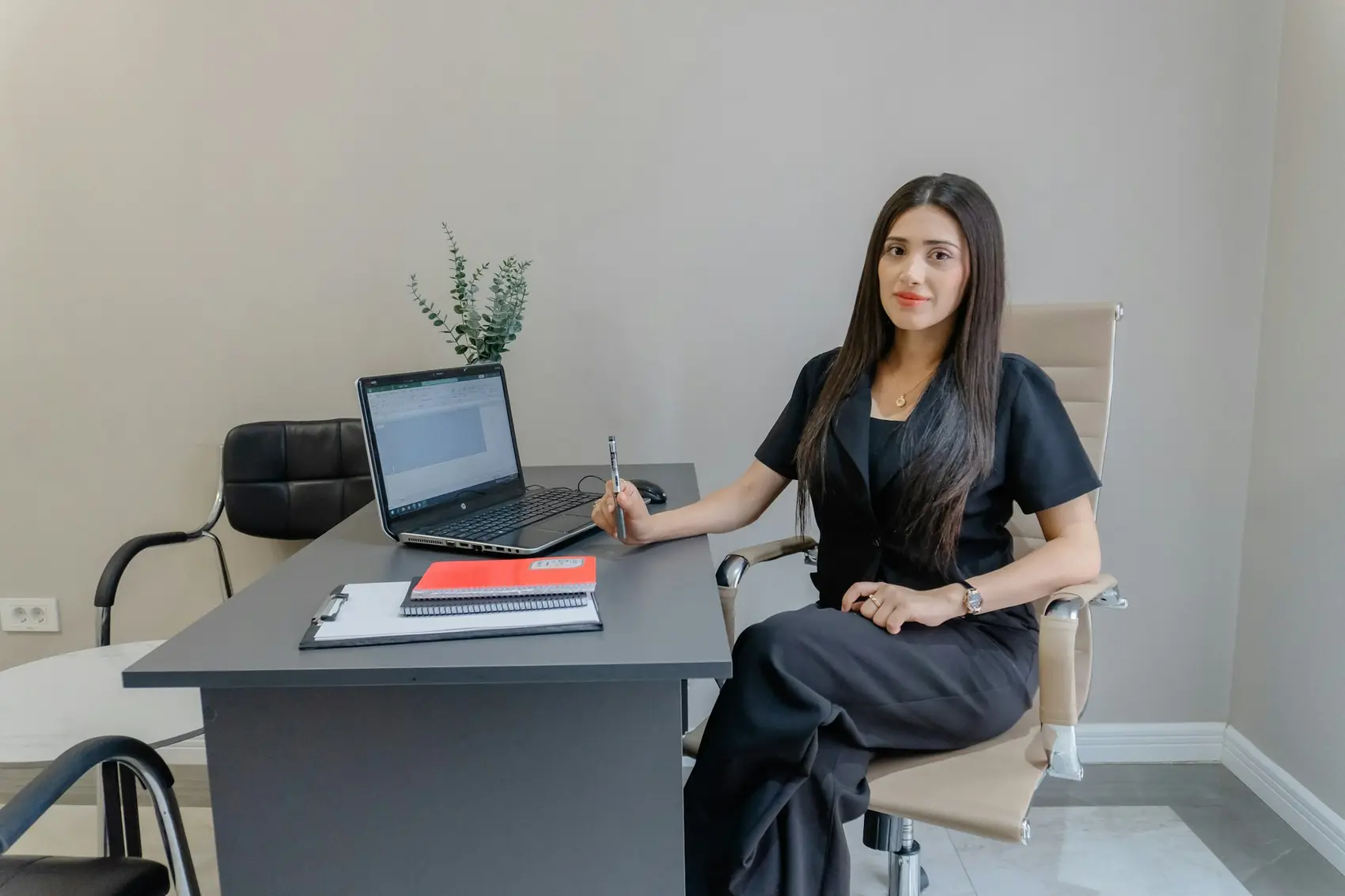 A woman at her desk with a laptop